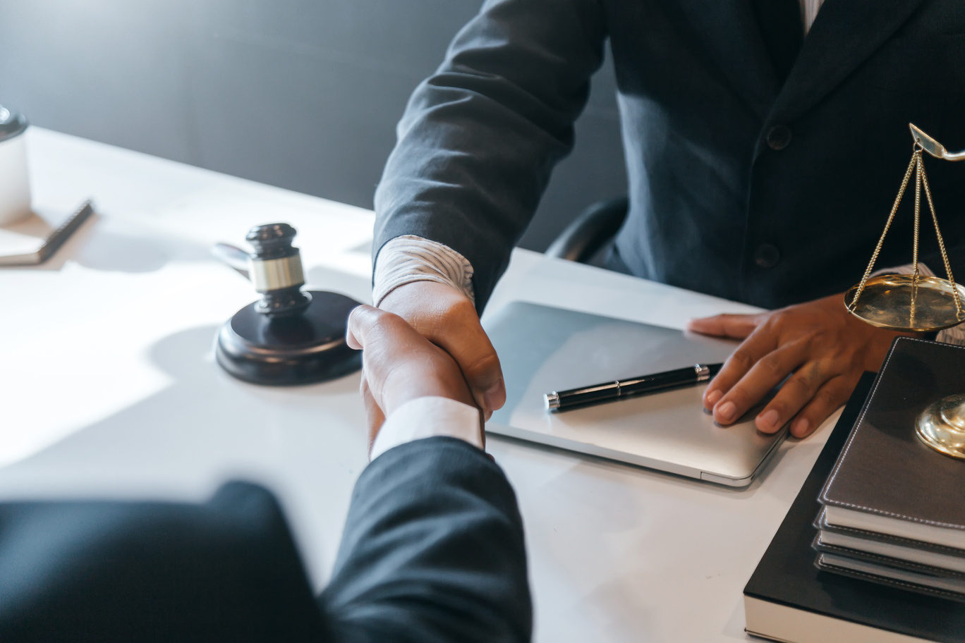 attorney and client handshake in a meeting