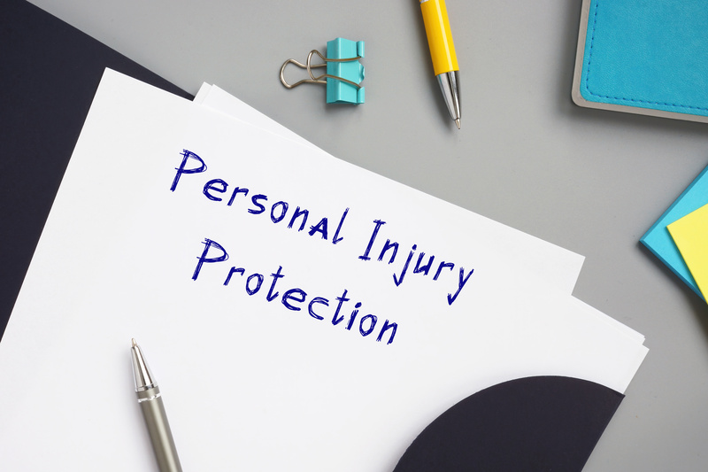 Personal Injury Protection written on the piece of paper.