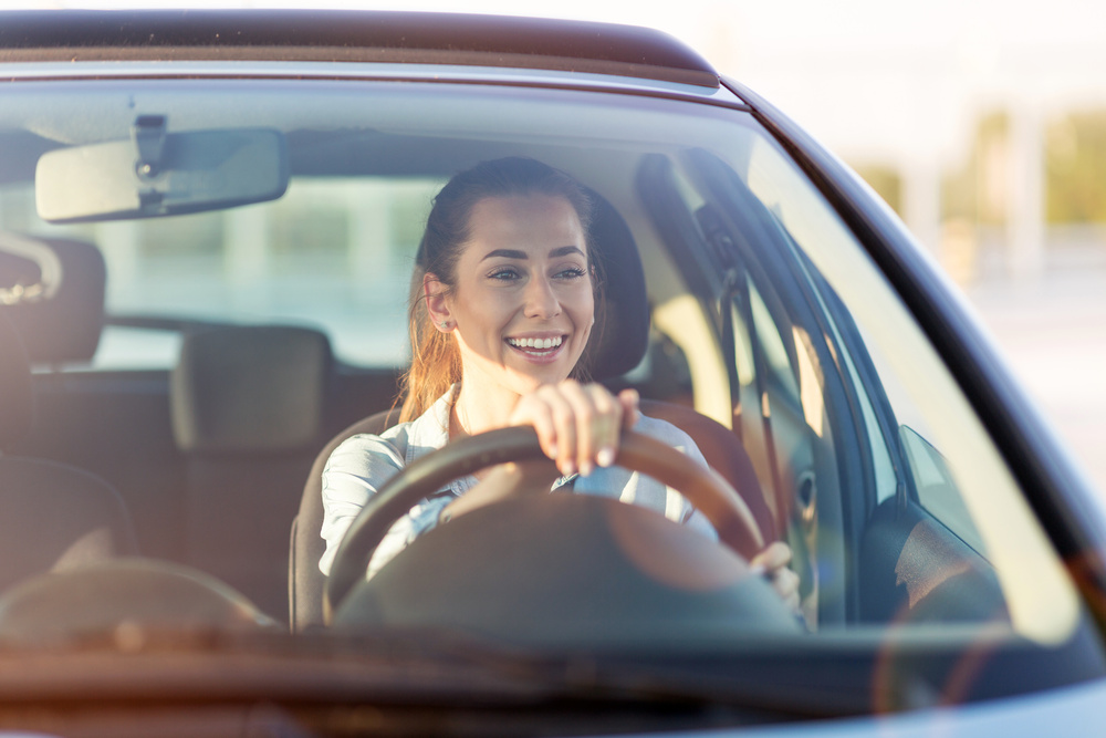 woman driving a car and smiling