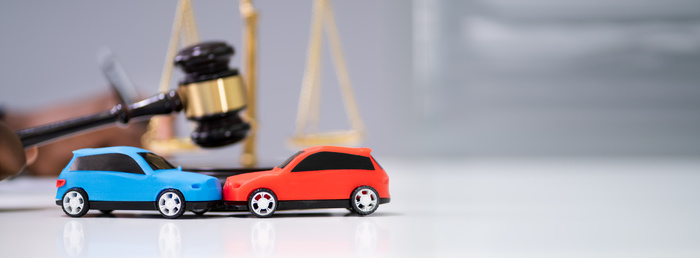 Two Cars On Desk In Courtroom - Car Accident Law concept